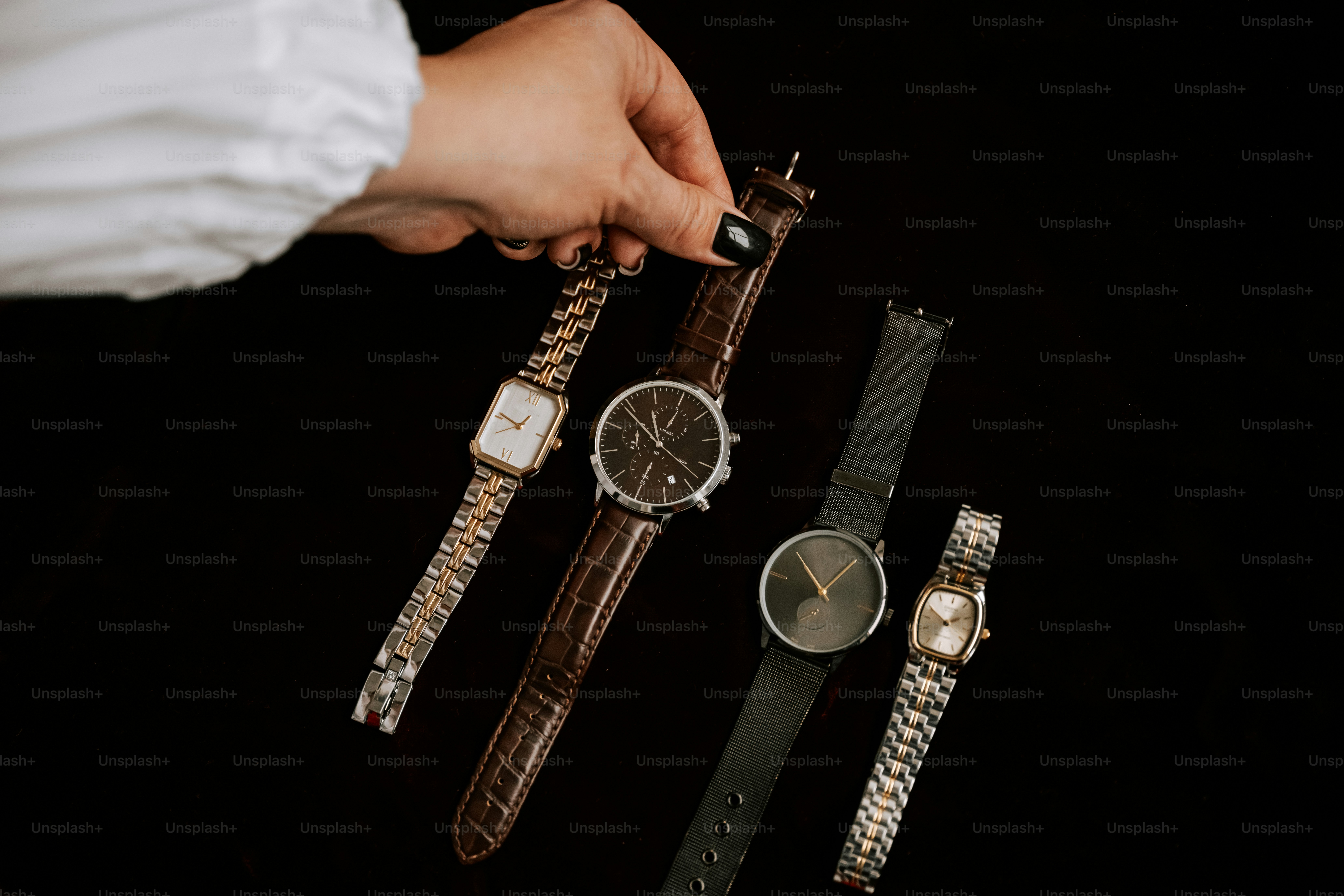 A person holding a watch in their hand